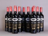 six bottles of wine are lined up in a row on a table