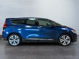 the blue car is parked in a large room with a white wall