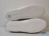 the soles of a pair of white shoes on a white surface
