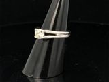 a close up of a ring with a diamond on top of a cone