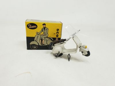 a toy scooter and a box on a white surface