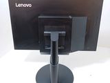 a computer monitor sitting on a stand on a white surface