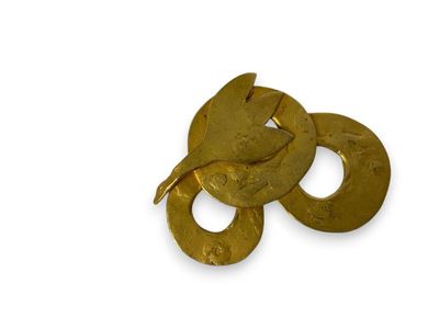 three gold rings that are on a white surface