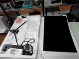 a laptop computer sitting on top of a white box