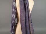 the scarf is on a mannequin head and has a design on it