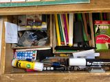 a wooden box with a lot of school supplies inside of it