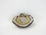 an image of a gold and silver broochle on a white background
