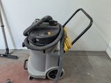 a vacuum that is sitting on the floor next to a wall