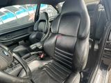 a picture of the interior of a car with black leather seats