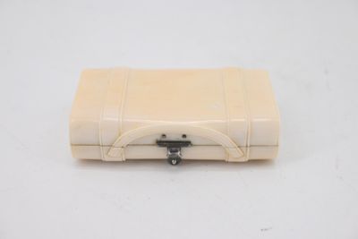 a small white suitcase sitting on a white surface