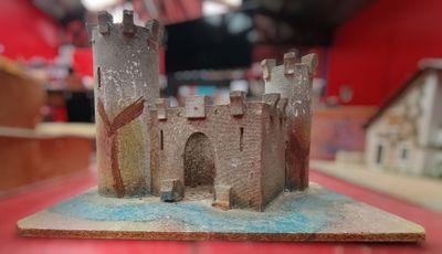 a small model of a castle on a red table