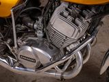 a close up of a yellow motorcycle with a black engine