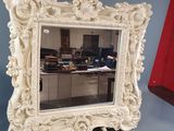 a mirror that is sitting on a table in a room