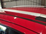 a red car with a surfboard on top of it