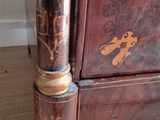 a wooden cabinet with a decorative design on it