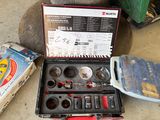 a tool kit sitting on the ground next to a box of tools