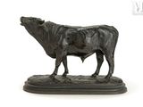 a statue of a cow that is standing on a base