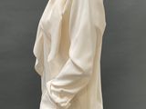 a mannequin dressed in a white shirt and white pants