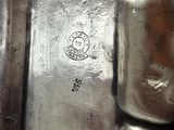 a close up view of a silver plate with a stamp on it