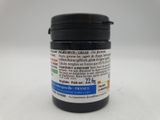 a close up of a jar of black liquid on a white surface