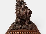 an image of a wooden sculpture of a tree with leaves on it