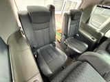 two seats in the back of a van with a window open