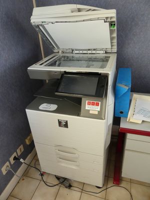 a printer that is sitting on top of a cabinet