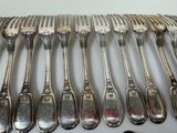 a lot of silver spoons and forks on a table