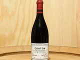 a bottle of wine sitting on top of a barrel