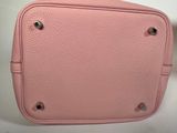a pink purse sitting on top of a white table