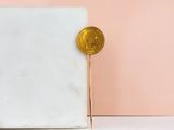a gold coin sitting on top of a marble block