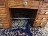 a wooden desk with drawers and drawers on it