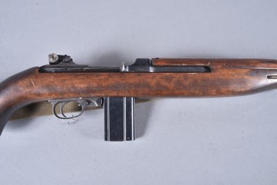 a close up of a rifle on a table with a gun in it