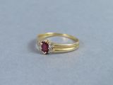 an image of a close up of a ring with a ruby stone