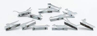 several pieces of metal are arranged in a circle on a white surface