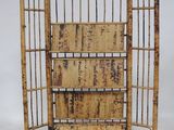 an image of a bamboo bookcase with four shelves on top of it