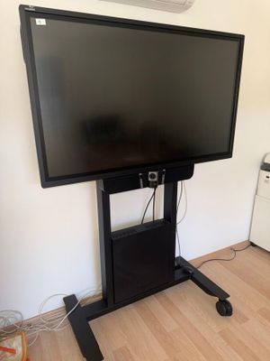 a flat screen tv sitting on a stand in a room