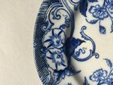 a blue and white plate with a floral design on it