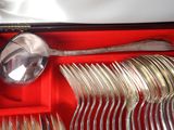 many spoons and forks in a red box