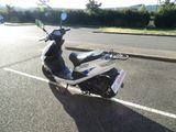 a scooter that is parked in the parking lot