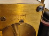 an image of a close up of a gold colored clock on a table