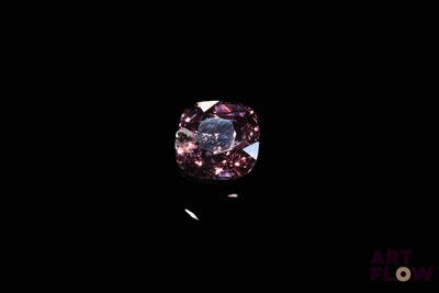 a close up of a pink diamond on a black background