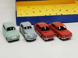 several toy cars are lined up in a row next to a box