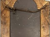 a mirror hanging on the wall with a rope around it