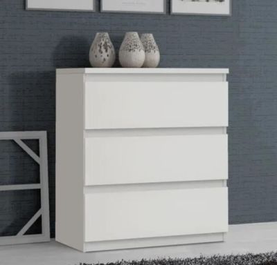 two vases on top of a white dresser in a room