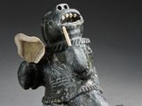 statue of a bear with a toothbrush in its mouth