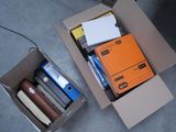 a cardboard box filled with books and other items on the floor