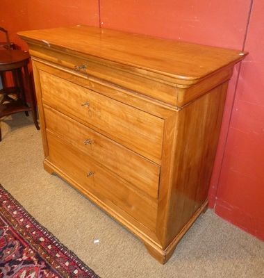 a wooden chest of drawers with a rug on the floor