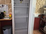 an image of a refrigerator in a kitchen with a clock on the door