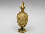 an antique gold vase with a statue on top of it